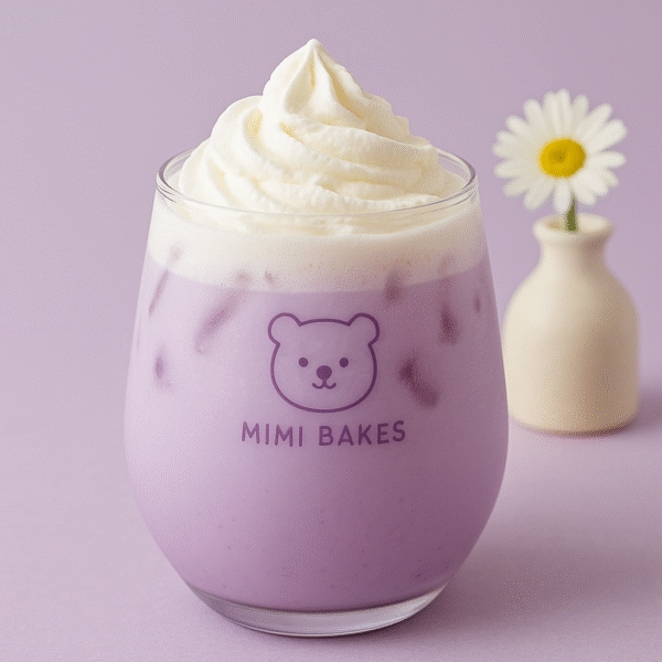 Ly sữa khoai môn mát lạnh với lớp kem tươi phía trên, đá viên, logo Mimi Bakes, nền tím pastel