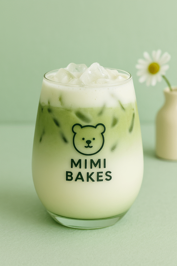 Ly matcha sữa dừa với đá viên, màu xanh và trắng hòa quyện, logo Mimi Bakes, nền xanh pastel