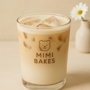 Ly bạc xỉu với lớp cà phê nhạt, kem sữa và đá viên, logo Mimi Bakes, nền pastel kem